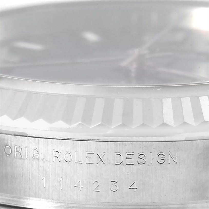 The image shows a close-up angle of the Rolex Air-King 114234 Men's Stainless Steel Blue Dial 114234 Men's Stainless Steel Blue Dial watch, featuring the engraved text and part of the bezel.