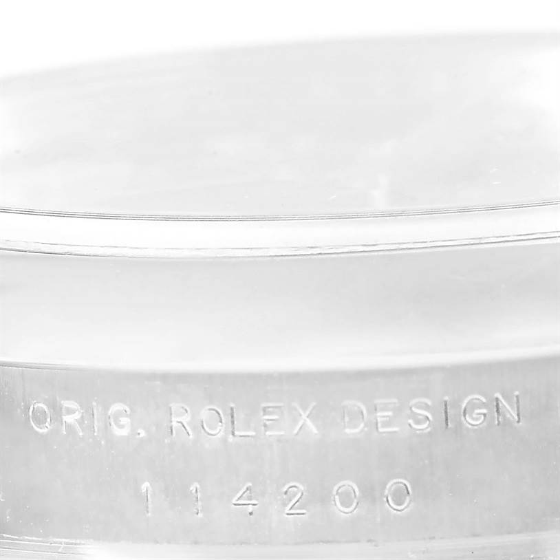 The image shows a close-up of the case side of the Rolex Air-King 114200 Men's Stainless Steel Blue Dial 114200 Men's Stainless Steel Blue Dial, displaying the engraving "ORIG. ROLEX DESIGN 114200."
