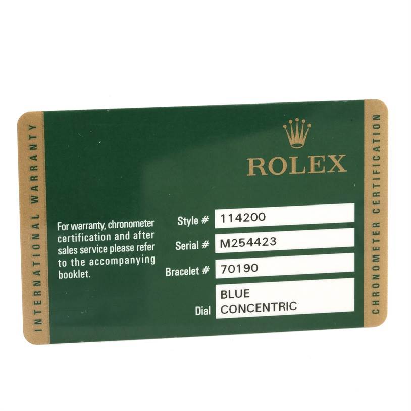 This image shows a green warranty card for the Rolex Air-King 114200 Men's Stainless Steel Blue Dial 114200 Men's Stainless Steel Blue Dial model, indicating style, serial, bracelet numbers, and dial type.
