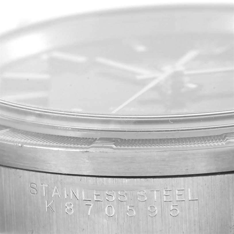 The image shows a close-up, side angle of the stainless steel case and part of the dial of a Rolex Air-King 14010 Men's Stainless Steel Black Dial 14010 Men's Stainless Steel Black Dial watch.