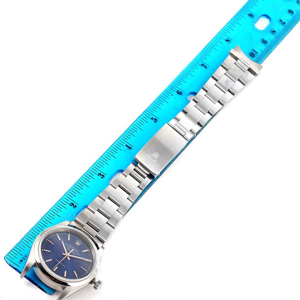 The Rolex Air-King 14000 Men's Stainless Steel Blue Dial 14000 Men's Stainless Steel Blue Dial watch is shown from above, displaying its face, bracelet, and clasp, with a ruler for scale.