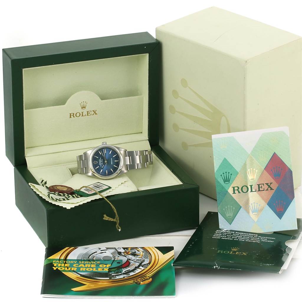 The image shows a Rolex Air-King 14000 Men's Stainless Steel Blue Dial 14000 Men's Stainless Steel Blue Dial watch from a front angle, inside its box, with accompanying booklets and tags.