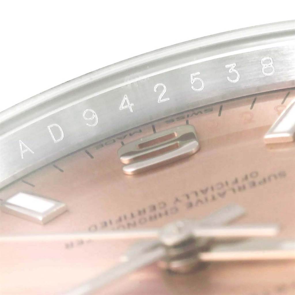 The image shows a close-up of the Rolex Air-King 114200 Men's Stainless Steel Pink Dial 114200 Men's Stainless Steel Pink Dial watch dial and serial number on the bezel.