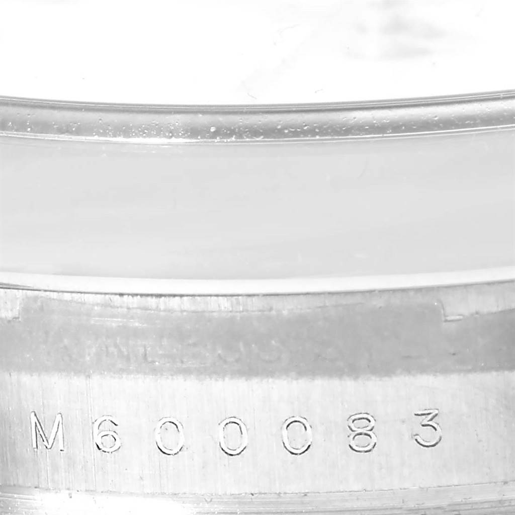 This image shows a close-up angle of the serial number engraving on the casing of a Rolex Air-King 114200 Men's Stainless Steel White Dial 114200 Men's Stainless Steel White Dial watch.