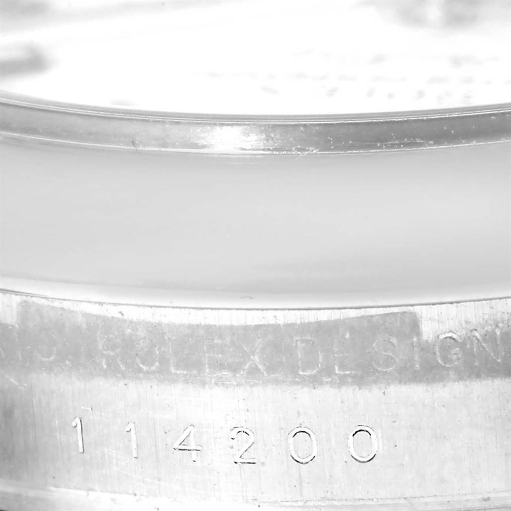 This image shows a close-up of the serial number engraving on the side of the bezel of a Rolex Air-King 114200 Men's Stainless Steel White Dial 114200 Men's Stainless Steel White Dial model watch.
