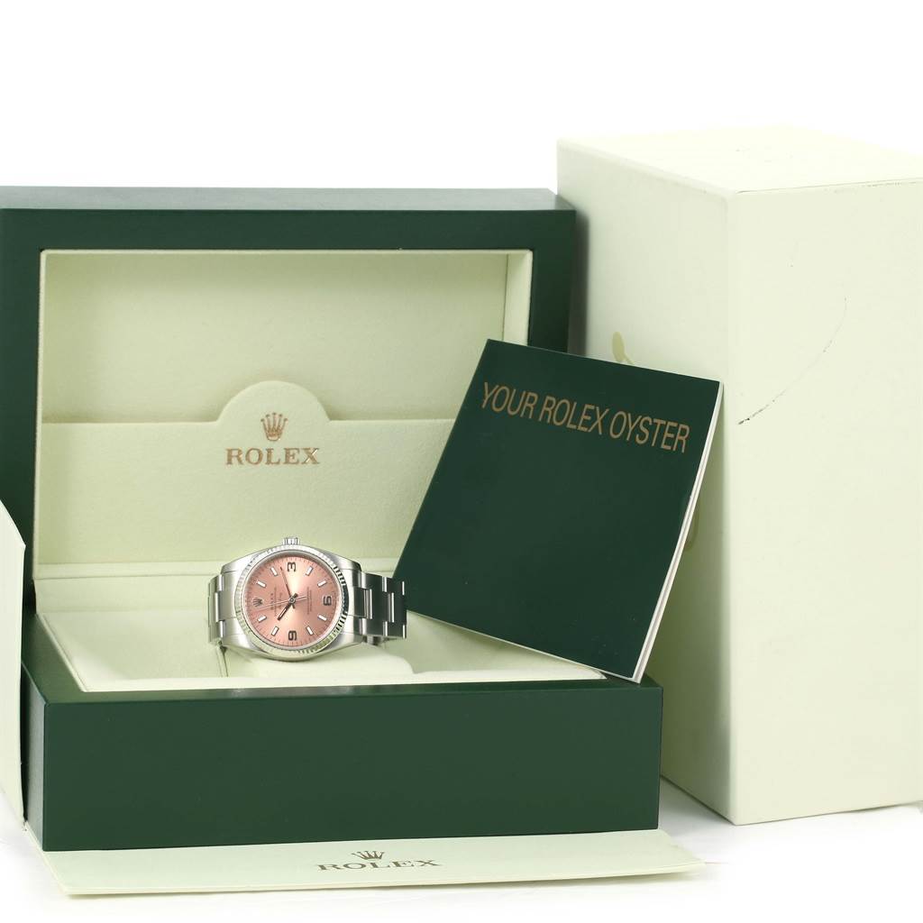 The image shows a Rolex Air-King 114234 Men's Stainless Steel Pink Dial 114234 Men's Stainless Steel Pink Dial watch with a pink dial in its box, along with a booklet labeled "Your Rolex Oyster."