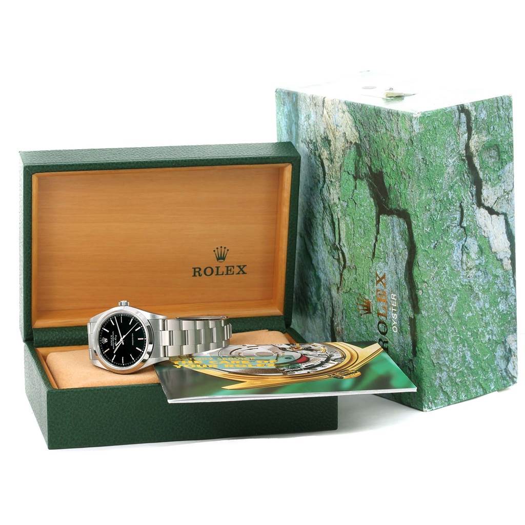 The Rolex Air-King 14000 Men's Stainless Steel Black Dial 14000 Men's Stainless Steel Black Dial watch is displayed at an angle inside its open green box, surrounded by its booklet and larger outer box.