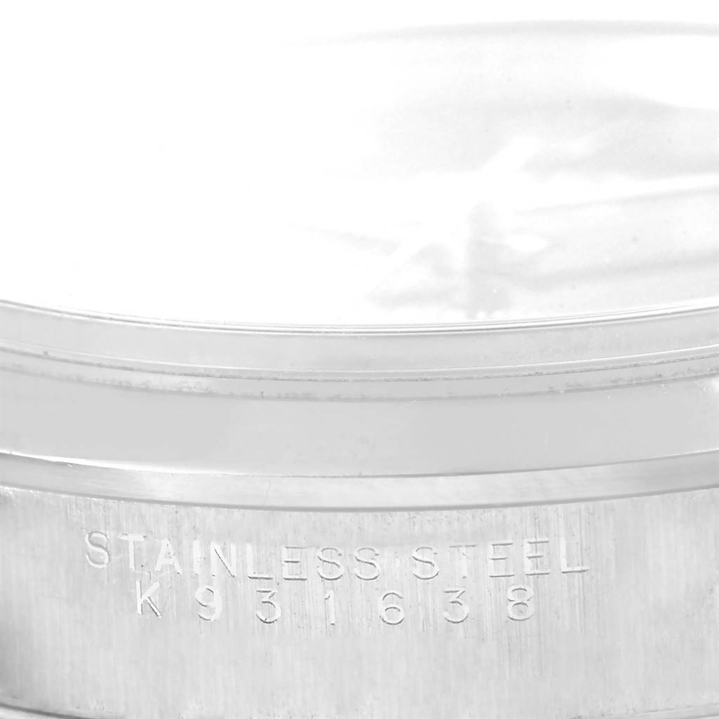 This image shows the side of the stainless steel case of a Rolex Air-King 14000 Men's Stainless Steel Black Dial 14000 Men's Stainless Steel Black Dial watch, highlighting the engraved serial number.