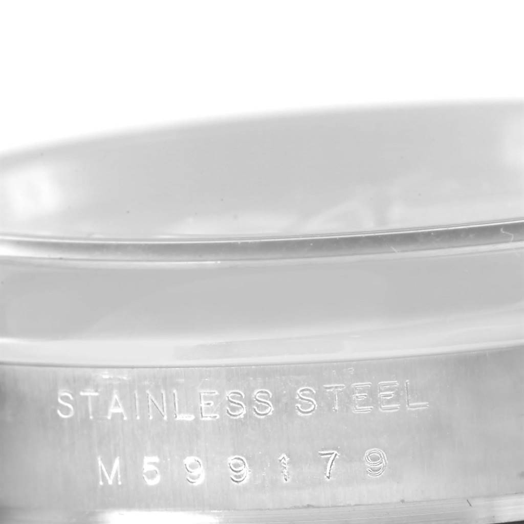 This image shows a close-up of the serial number and material engraving on the case back of a Rolex Air-King 114200 Men's Stainless Steel Silver Dial 114200 Men's Stainless Steel Silver Dial watch.