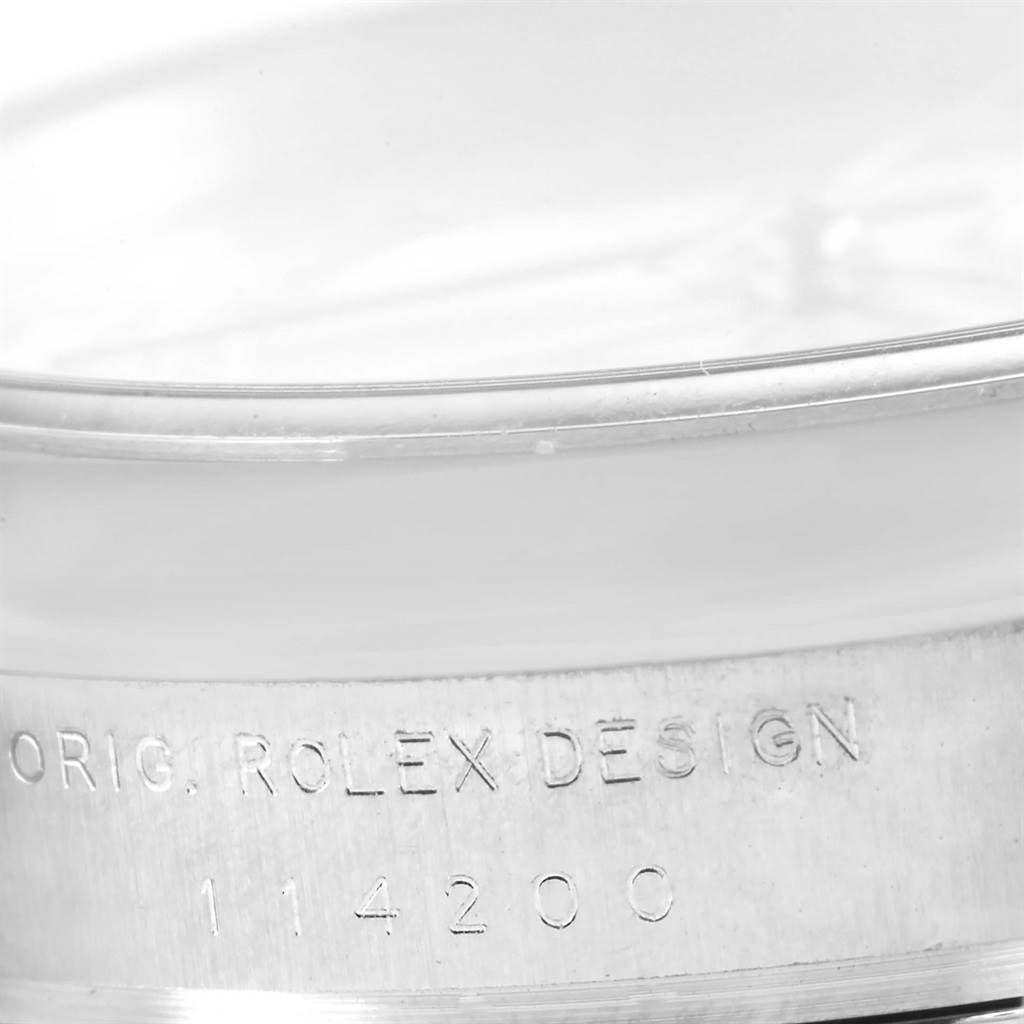 The image shows a close-up of the engraved case side of a Rolex Air-King 114200 Men's Stainless Steel Silver Dial 114200 Men's Stainless Steel Silver Dial watch, model number 114200.