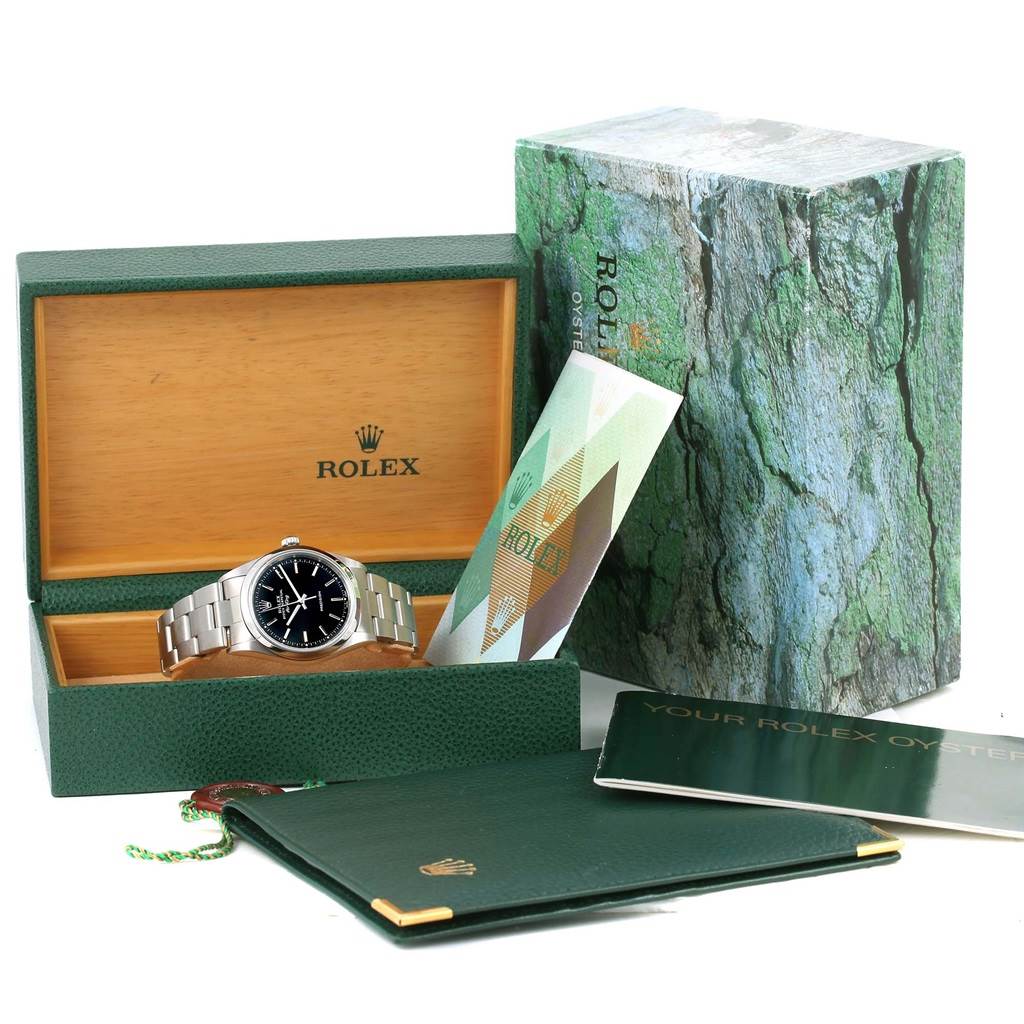The image shows a Rolex Air-King 14000 Men's Stainless Steel Black Dial 14000 Men's Stainless Steel Black Dial watch placed in an open box, alongside its papers and outer packaging from a front angle.