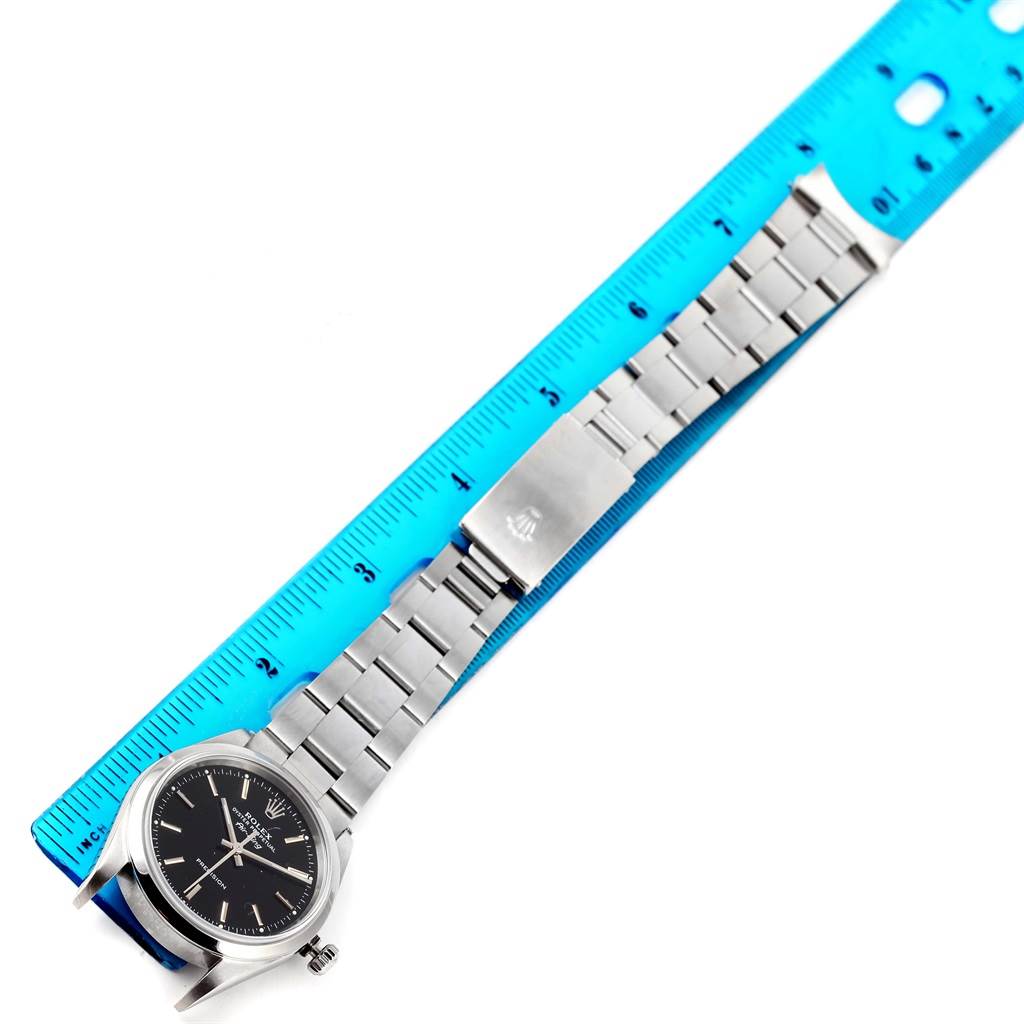 The image shows a Rolex Air-King 14000 Men's Stainless Steel Black Dial 14000 Men's Stainless Steel Black Dial watch laid flat against a blue ruler, displaying its face, bracelet, and clasp.