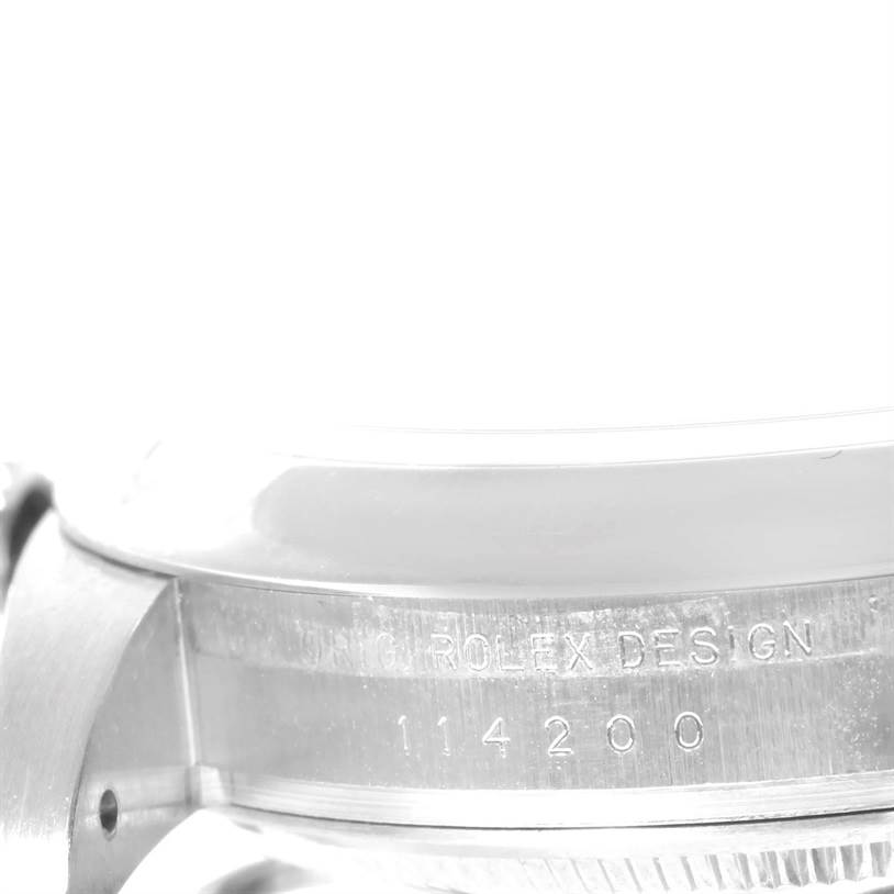 Close-up of the side of a Rolex Air-King 114200 Men's Stainless Steel Silver Dial 114200 Men's Stainless Steel Silver Dial watch showing the "Rolex Design 114200" engraving.