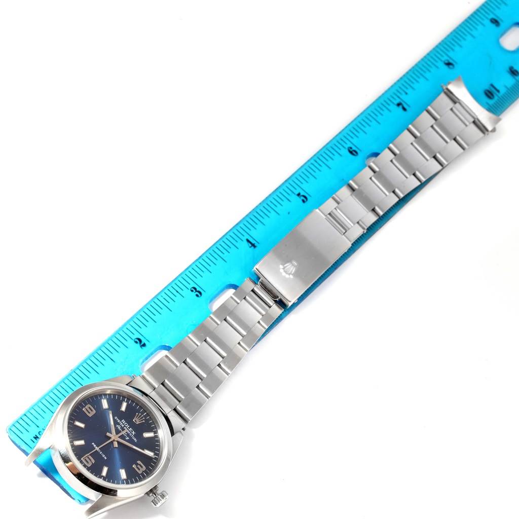 This image shows a Rolex Air-King 14000 Men's Stainless Steel Blue Dial 14000 Men's Stainless Steel Blue Dial watch positioned next to a ruler, displaying its bracelet and clasp.