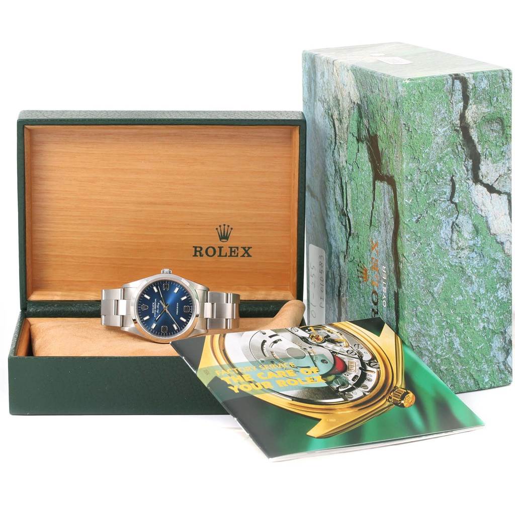 The Rolex Air-King 14000 Men's Stainless Steel Blue Dial 14000 Men's Stainless Steel Blue Dial is shown in its open box, accompanied by its outer box and an instruction booklet.