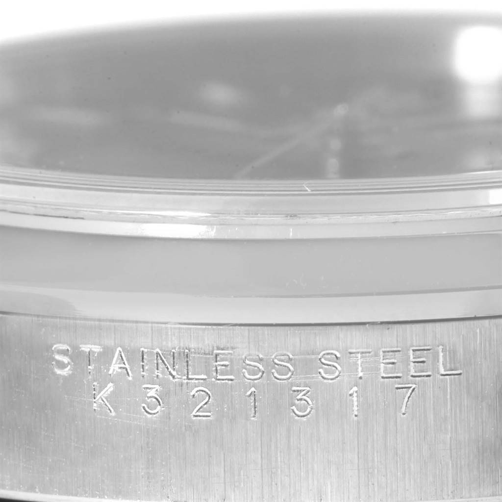 The image shows a close-up side view of an Air-King Rolex watch, focusing on the stainless steel engraving with serial number K321317.