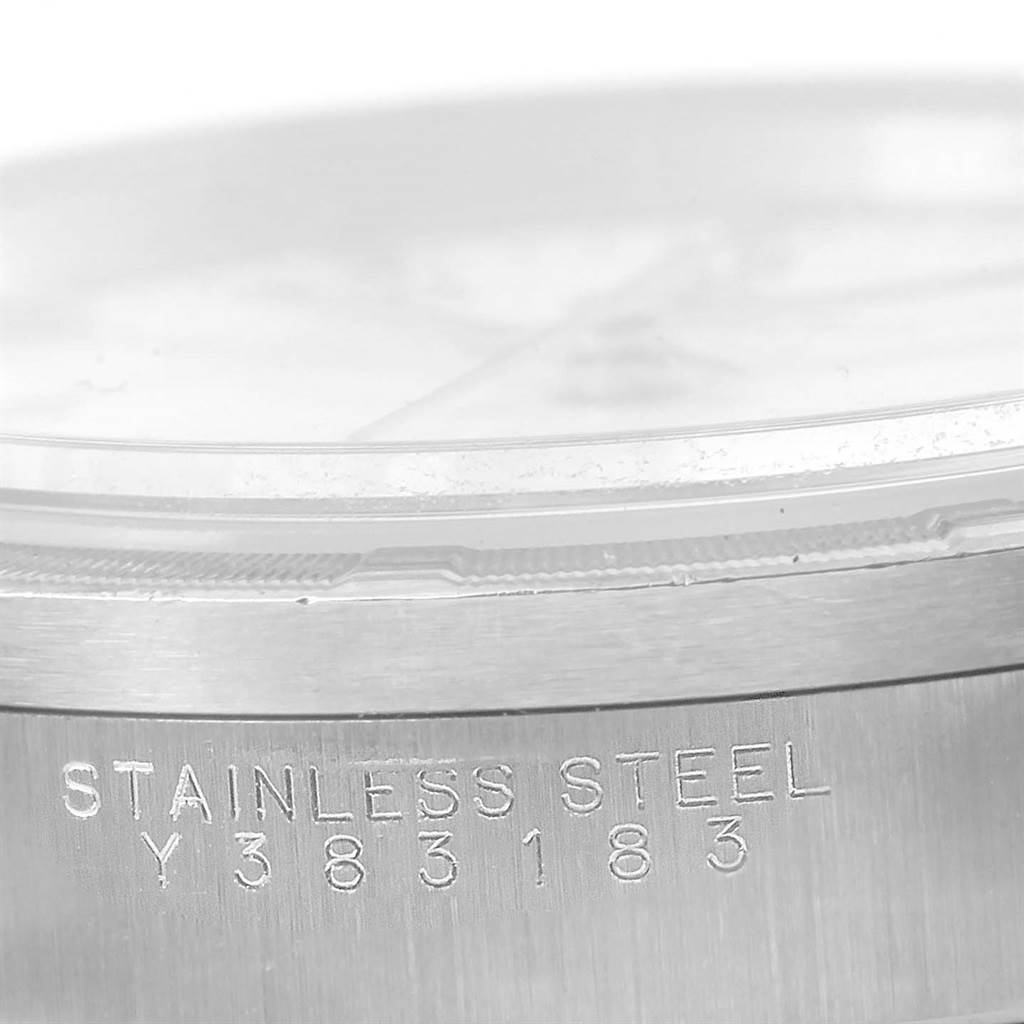The image shows a close-up of the side of a Rolex Air-King 14010 Men's Stainless Steel White Dial 14010 Men's Stainless Steel White Dial watch, highlighting the "STAINLESS STEEL" engraving and serial number.