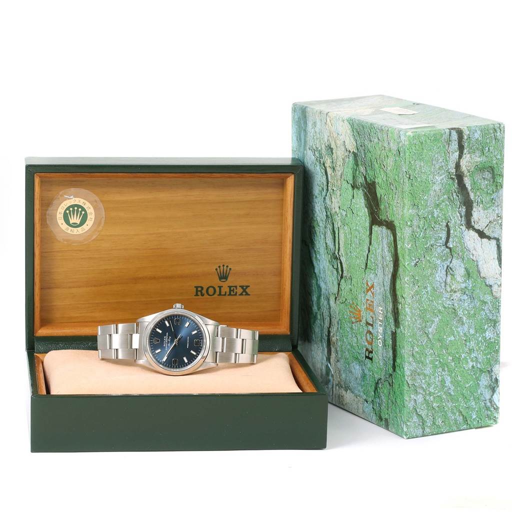The image shows a Rolex Air-King 14000 Men's Stainless Steel Blue Dial 14000 Men's Stainless Steel Blue Dial watch displayed in an open green box with the outer packaging visible beside it.