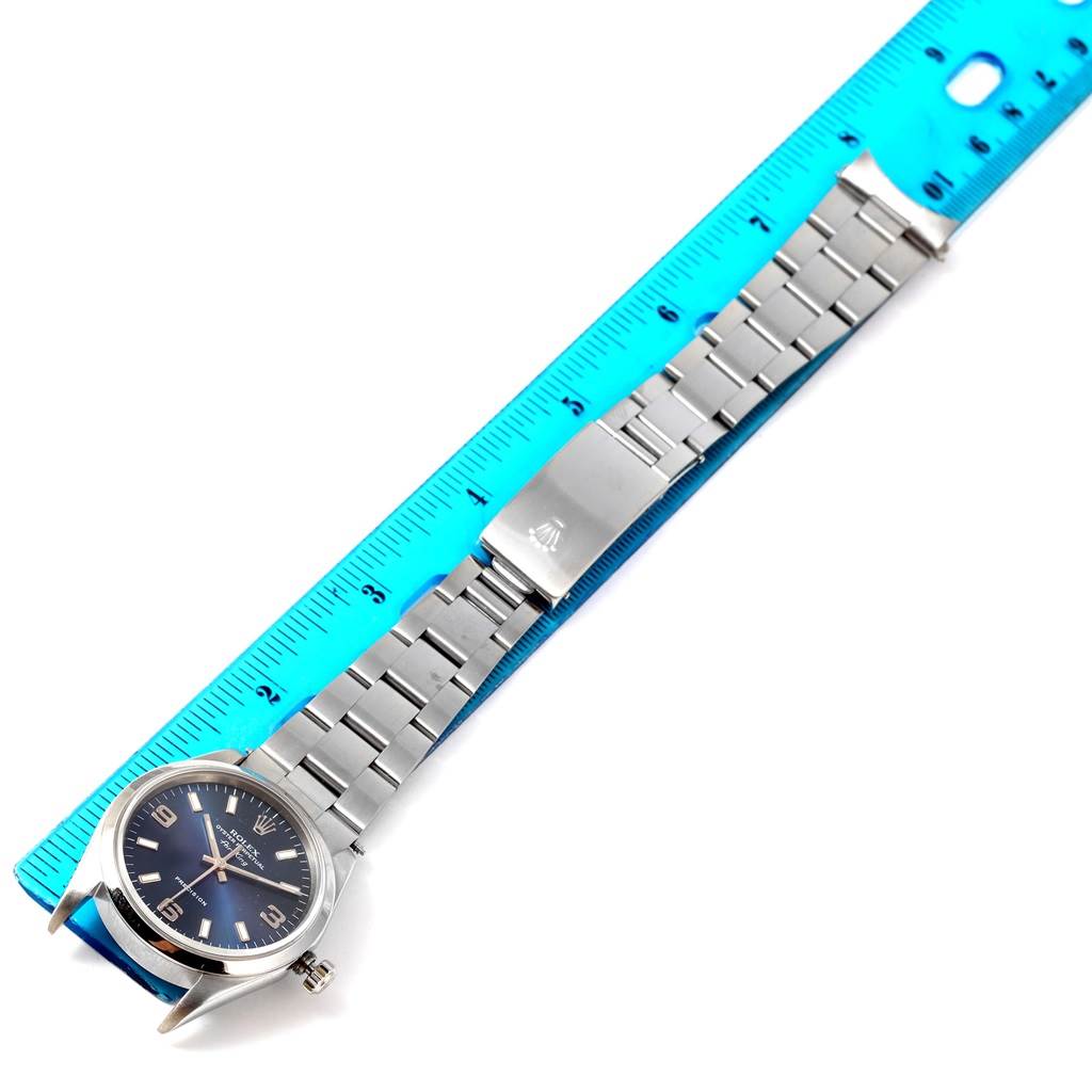 The image shows a Rolex Air-King 14000 Men's Stainless Steel Blue Dial 14000 Men's Stainless Steel Blue Dial watch laid flat next to a ruler, showcasing its bracelet and clasp.