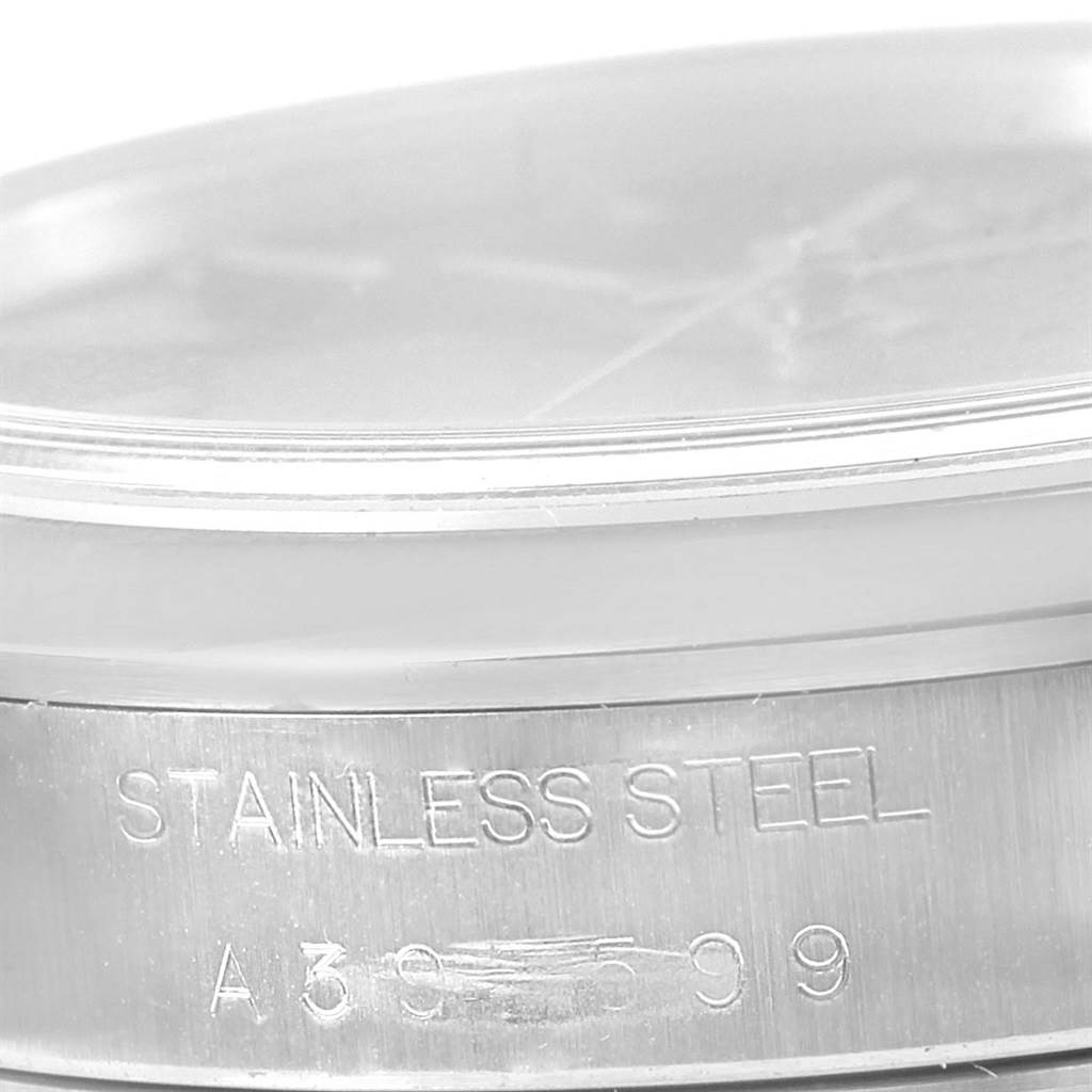 The image shows a close-up of the side of a Rolex Air-King 14000 Men's Stainless Steel Black Dial 14000 Men's Stainless Steel Black Dial watch, specifically the stainless steel case with engraved details.