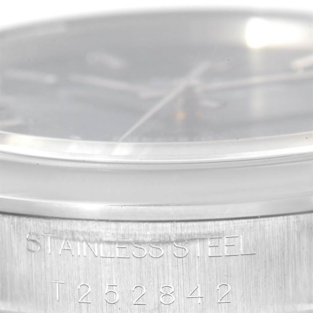 Close-up shot of the side of a Rolex Air-King 14000 Men's Stainless Steel Blue Dial 14000 Men's Stainless Steel Blue Dial watch, showing the words "STAINLESS STEEL" and the model number.