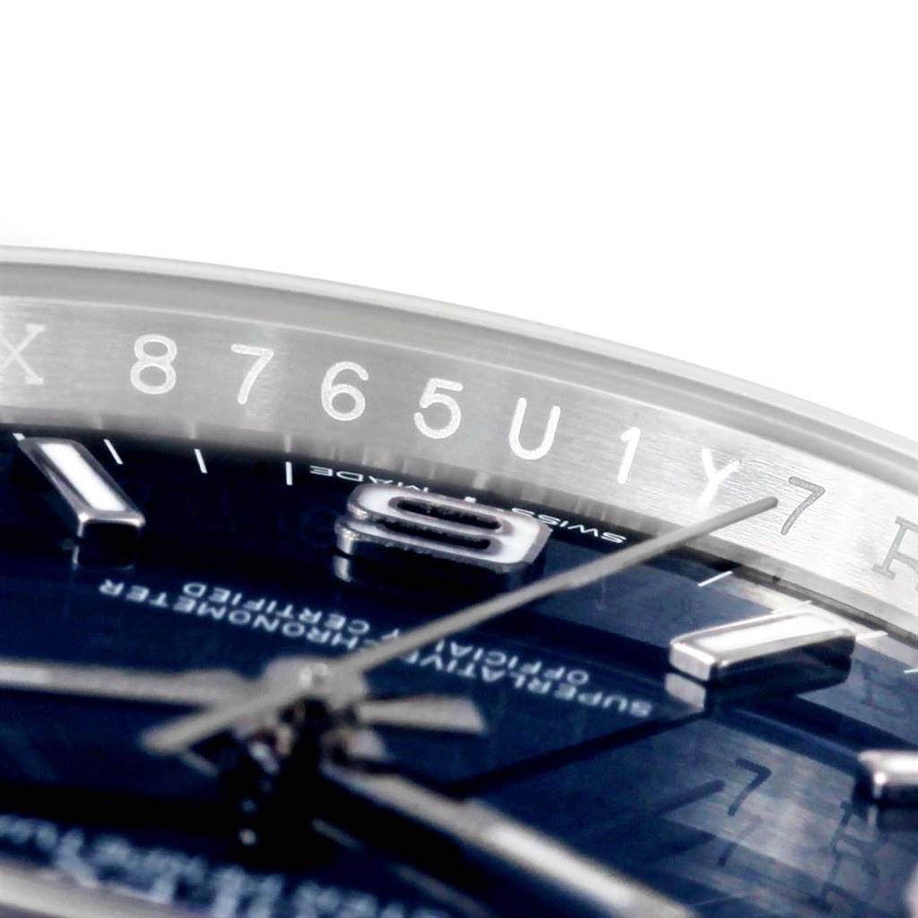 The image shows a close-up of the Rolex Air-King 116000 Men's Stainless Steel Blue Dial 116000 Men's Stainless Steel Blue Dial watch dial with visible hour markers and partially visible second hand.