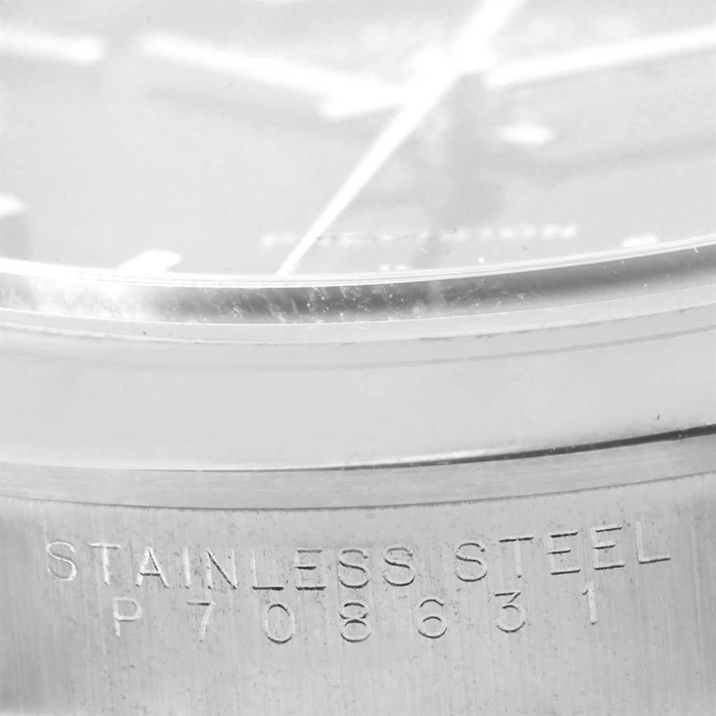 The image shows a close-up of the side case of a Rolex Air-King 14000 Men's Stainless Steel Black Dial 14000 Men's Stainless Steel Black Dial watch, highlighting the "STAINLESS STEEL" engraving and partial view of the dial.