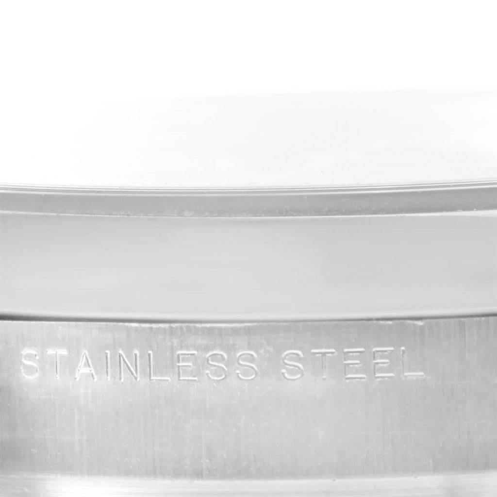 This close-up image shows the side of the stainless steel case of the Rolex Air-King 114200 Men's Stainless Steel Blue Dial 114200 Men's Stainless Steel Blue Dial watch.