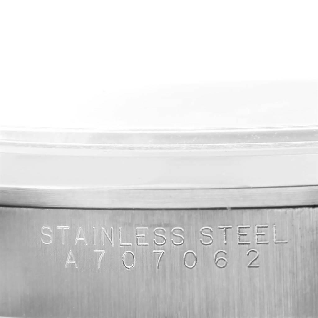 This image shows a close-up view of the serial number and "STAINLESS STEEL" inscription on the side of a Rolex Air-King 14000 Men's Stainless Steel Blue Dial 14000 Men's Stainless Steel Blue Dial watch.