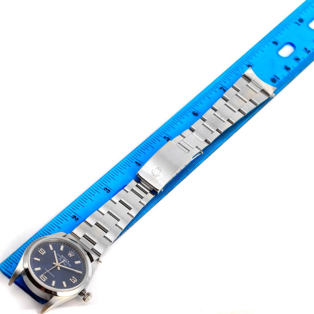 The image shows a Rolex Air-King 14000 Men's Stainless Steel Blue Dial 14000 Men's Stainless Steel Blue Dial watch laid flat next to a blue ruler, displaying its band and clasp.