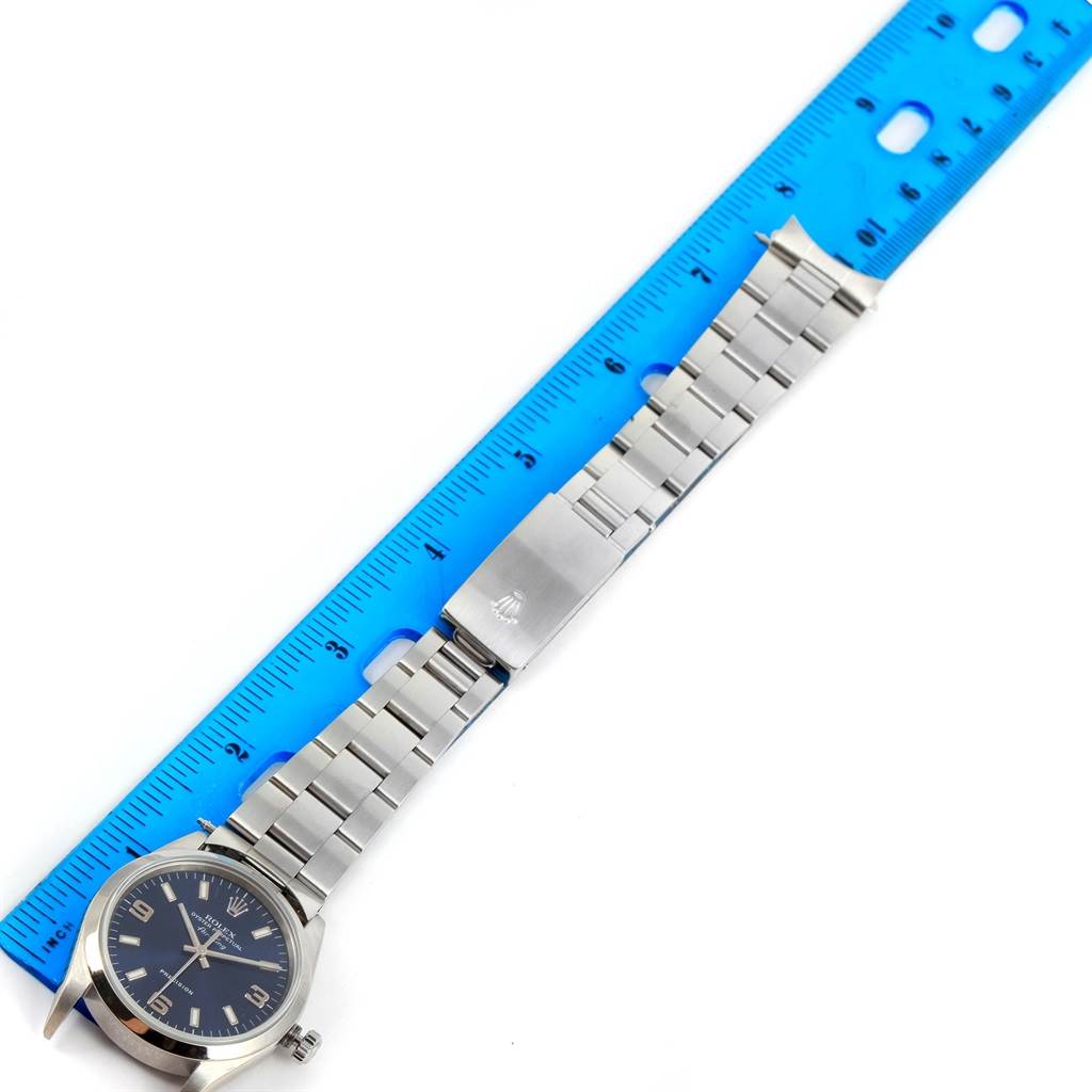 The Rolex Air-King 14000 Men's Stainless Steel Blue Dial 14000 Men's Stainless Steel Blue Dial watch is shown laid flat next to a ruler, displaying the face, band, and clasp.