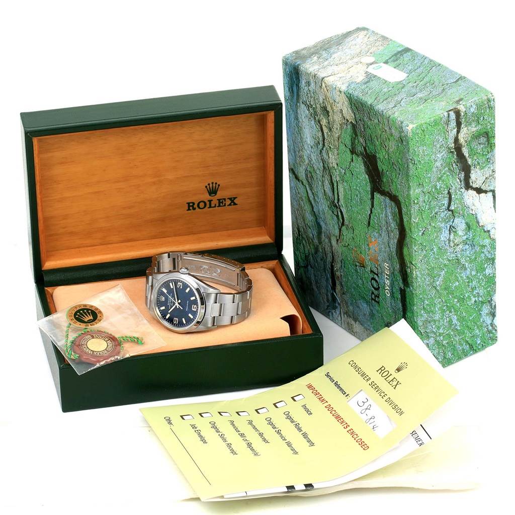 The image shows a Rolex Air-King 14000 Men's Stainless Steel Blue Dial 14000 Men's Stainless Steel Blue Dial watch in an open box, along with its accessories and documentation.