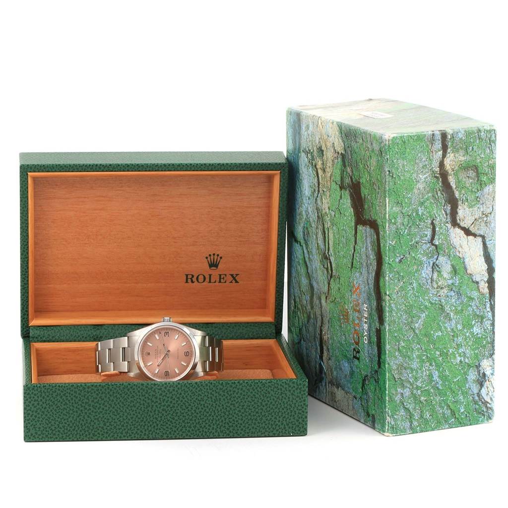 The Rolex Air-King 14000 Men's Stainless Steel Pink Dial 14000 Men's Stainless Steel Pink Dial watch is displayed inside an open green and wooden box with its external packaging shown beside it.