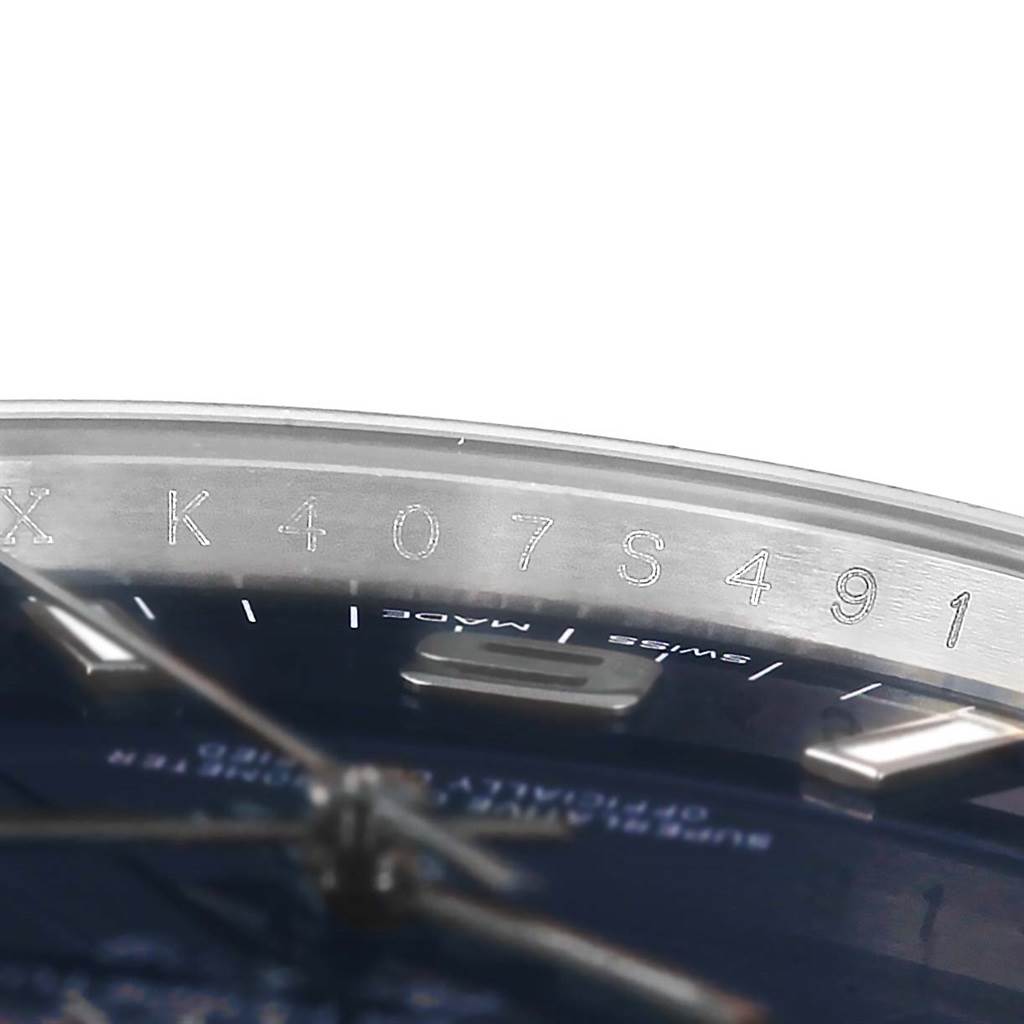 The image shows a close-up of the engraved serial number on the inner bezel of a Rolex Air-King 114200 Men's Stainless Steel Blue Dial 114200 Men's Stainless Steel Blue Dial watch.