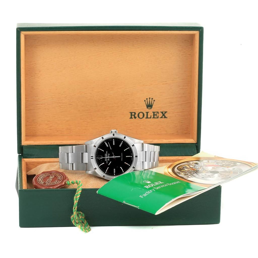 This image shows a Rolex Air-King 14010 Men's Stainless Steel Black Dial 14010 Men's Stainless Steel Black Dial watch displayed in its box with its manual and tag.