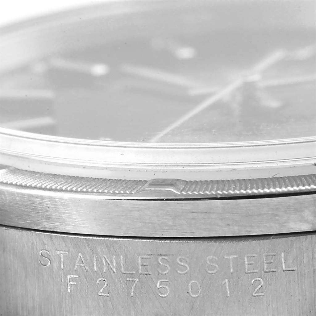 Close-up of the edge of the dial and the engraved stainless steel case of a Rolex Air-King 14010 Men's Stainless Steel Black Dial 14010 Men's Stainless Steel Black Dial watch.