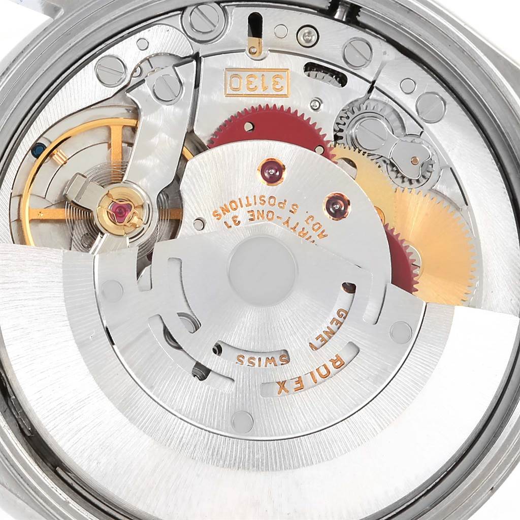 This image shows the intricate inner mechanical components of a Rolex Air-King 14010 Men's Stainless Steel Black Dial 14010 Men's Stainless Steel Black Dial watch with visible gears and the balance wheel.