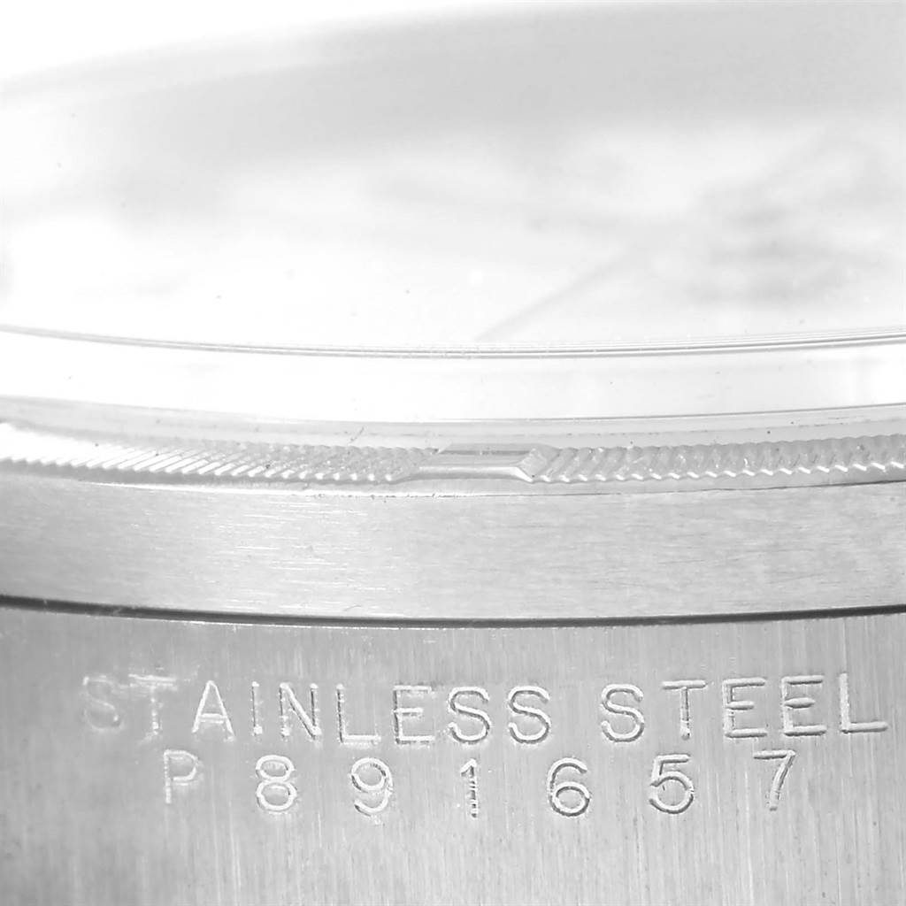 The image shows a close-up of the stainless steel case side and bezel of a Rolex Air-King 14010 Men's Stainless Steel White Dial 14010 Men's Stainless Steel White Dial watch, highlighting the serial number.