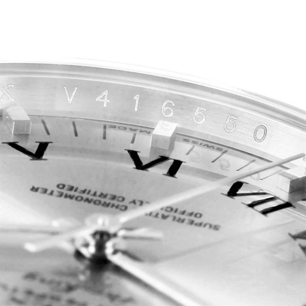 This image shows a close-up, angled view of the Rolex Air-King 114200 Men's Stainless Steel Grey Dial 114200 Men's Stainless Steel Grey Dial model, highlighting its dial and part of the serial number.