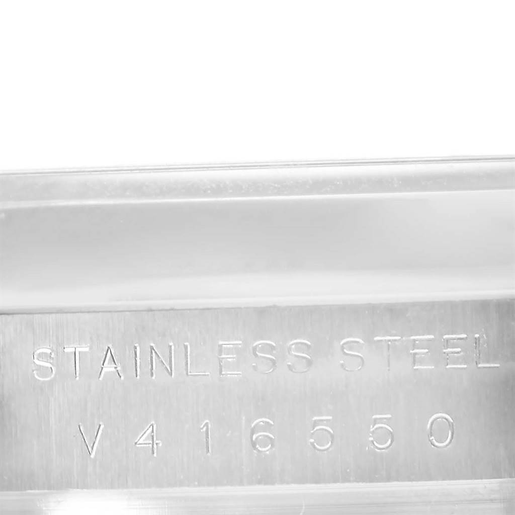 This image shows a close-up of the stainless steel case with the serial number of a Rolex Air-King 114200 Men's Stainless Steel Grey Dial 114200 Men's Stainless Steel Grey Dial watch.