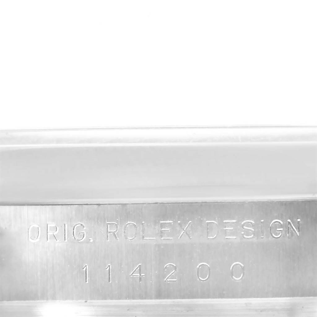 This image shows the engraved serial number and "ORIG. ROLEX DESIGN" on the case side of the Rolex Air-King 114200 Men's Stainless Steel Grey Dial 114200 Men's Stainless Steel Grey Dial watch model 114200.