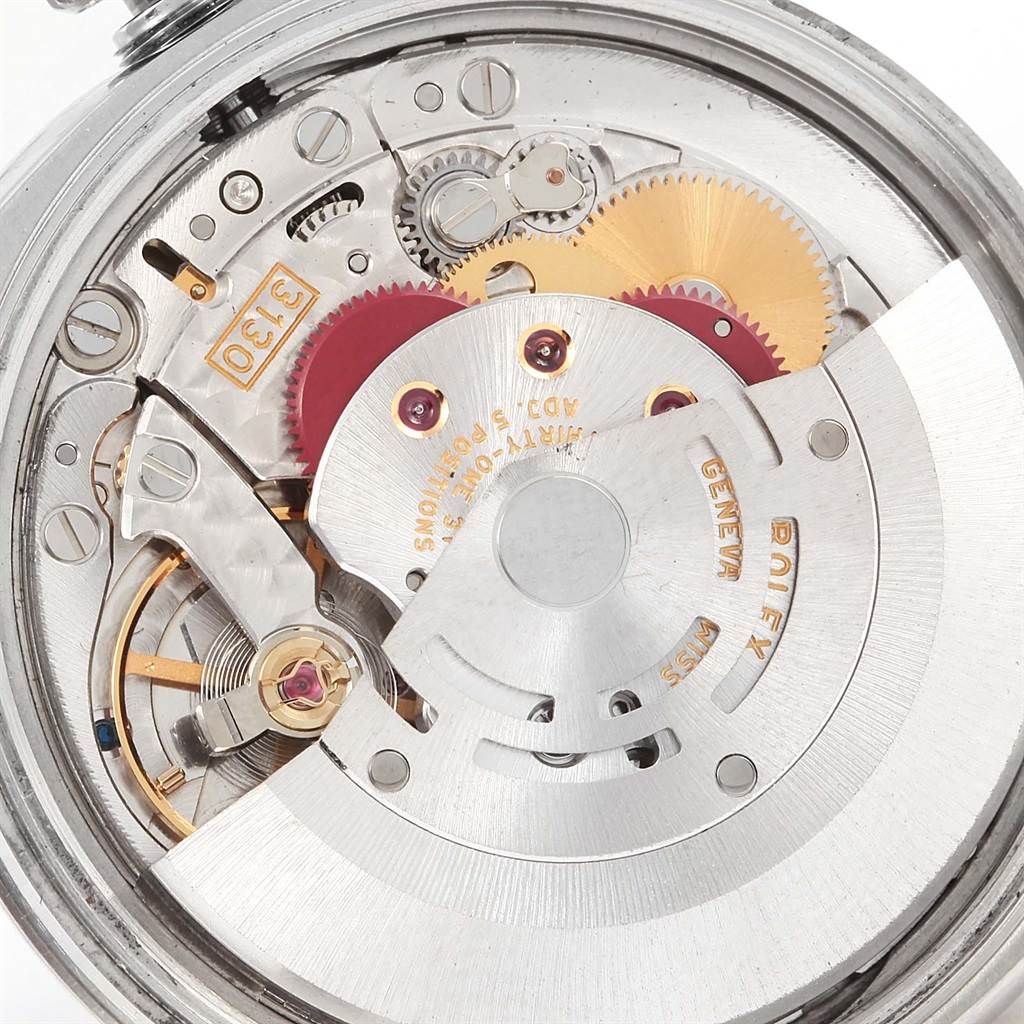 This image shows an angled view of the intricate internal mechanism of a Rolex Air-King 114210 Men's Stainless Steel Blue Dial 114210 Men's Stainless Steel Blue Dial watch, exposing gears and moving parts.