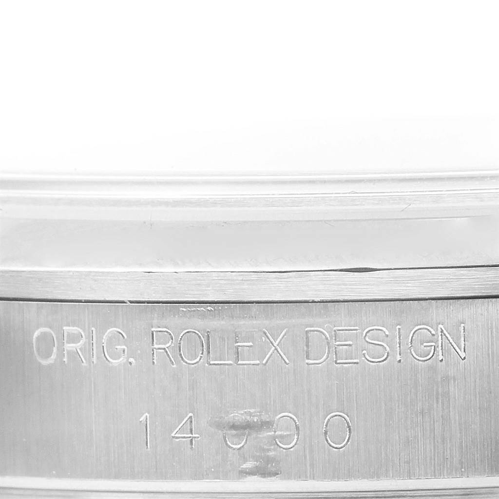 This image is a close-up of the bezel edge of a Rolex Air-King 14000 Women's Stainless Steel Blue Dial 14000 Women's Stainless Steel Blue Dial watch, showing the engraved text "ORIG. ROLEX DESIGN 14000".