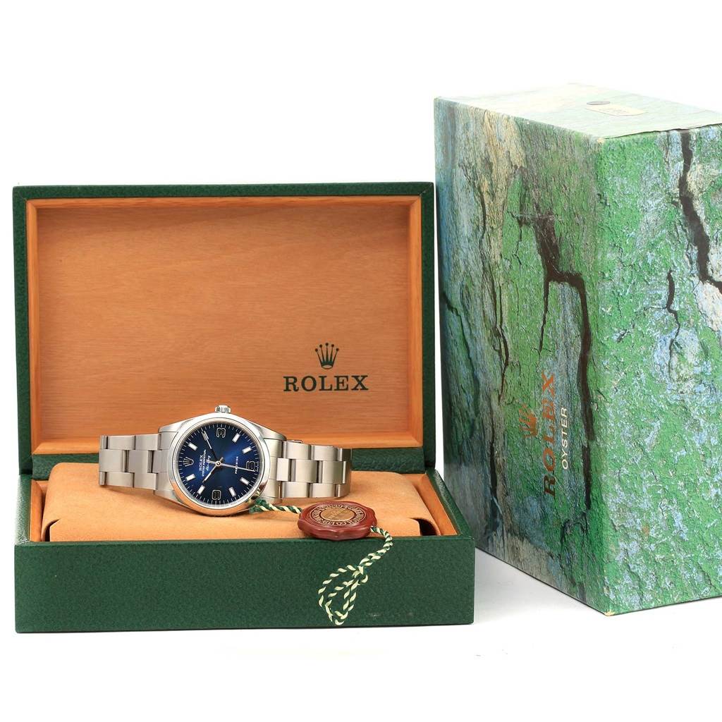 The image shows a Rolex Air-King 14000 Women's Stainless Steel Blue Dial 14000 Women's Stainless Steel Blue Dial watch positioned inside an open box with the outer green packaging displayed beside it.