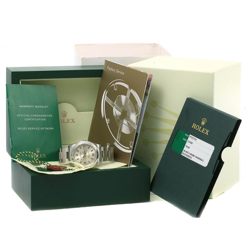 The image shows a Rolex Air-King 114200 Men's Stainless Steel Silver Dial 114200 Men's Stainless Steel Silver Dial watch with its box, warranty booklets, and factory service manuals.