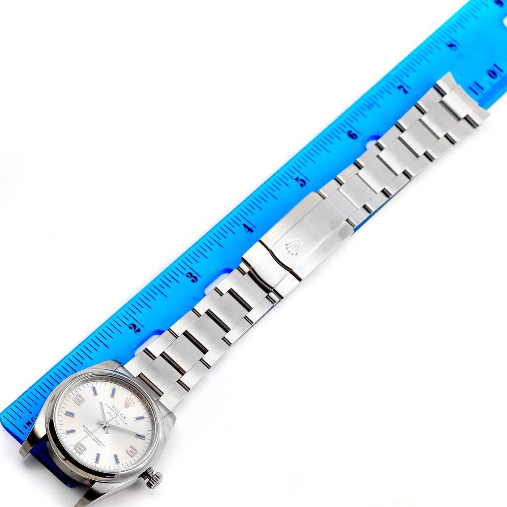 The image shows a Rolex Air-King 114200 Men's Stainless Steel Silver Dial 114200 Men's Stainless Steel Silver Dial watch laid flat next to a ruler, displaying the face and metal bracelet.
