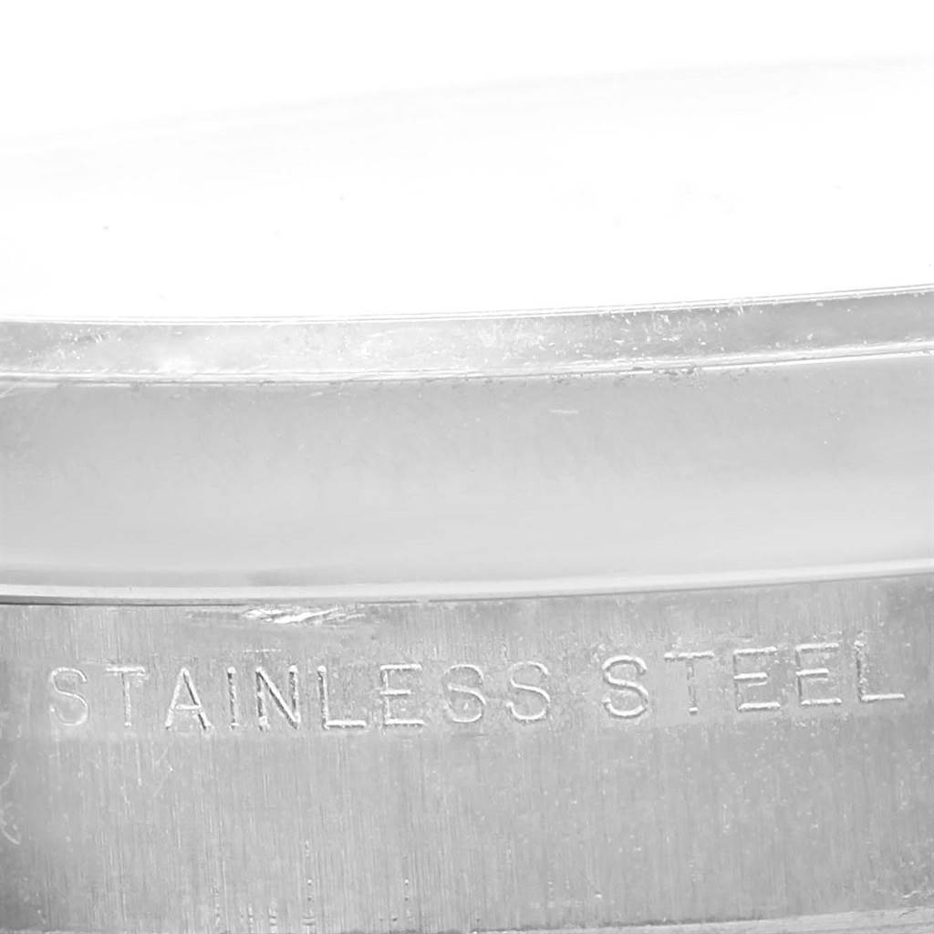 This image shows a close-up of the stainless steel casing of a Rolex Air-King 114200 Men's Stainless Steel Silver Dial 114200 Men's Stainless Steel Silver Dial watch.