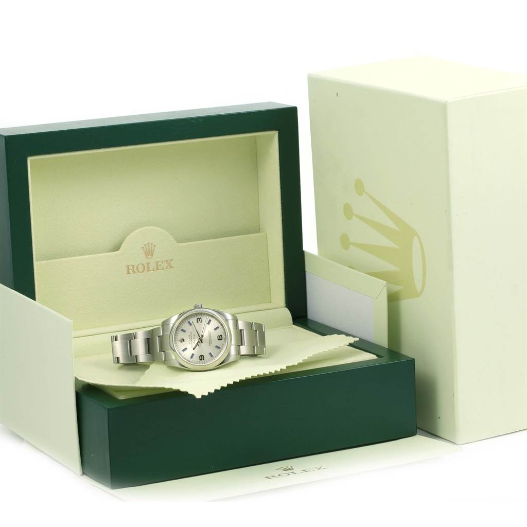 The Rolex Air-King 114200 Men's Stainless Steel Silver Dial 114200 Men's Stainless Steel Silver Dial watch is displayed in an open box, viewed from a front angle, showing its bracelet and face.