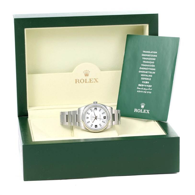 The image shows a Rolex Air-King 114200 Men's Stainless Steel White Dial 114200 Men's Stainless Steel White Dial watch in its open box with a booklet on the right side.