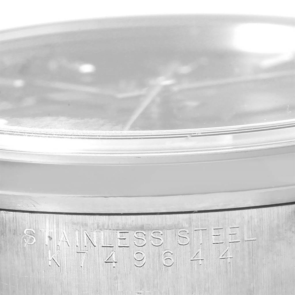 The image shows a partial side view of a Rolex Air-King 14000 Men's Stainless Steel Black Dial 14000 Men's Stainless Steel Black Dial watch, focusing on the stainless steel casing with its engraved serial number.